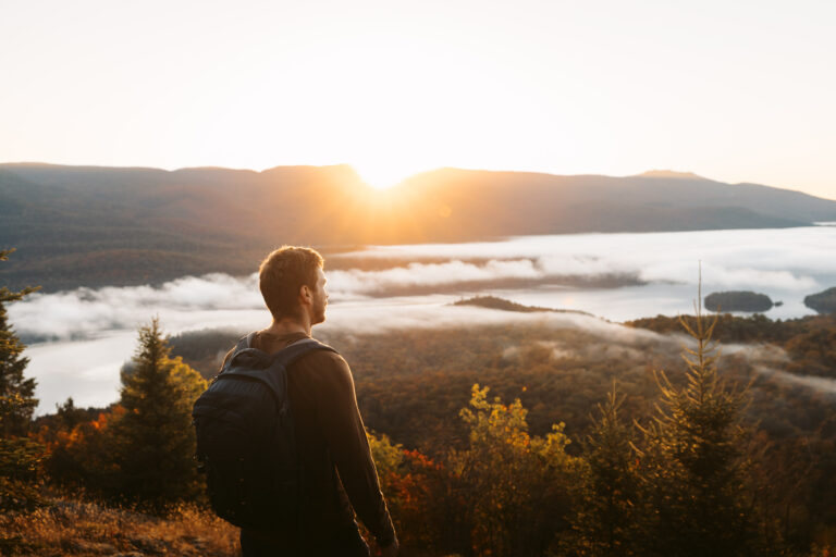 man looking at fall inversion from a summit